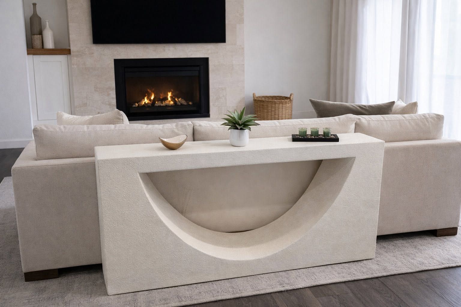A white foam console table with a curved cutout in front of a fireplace
