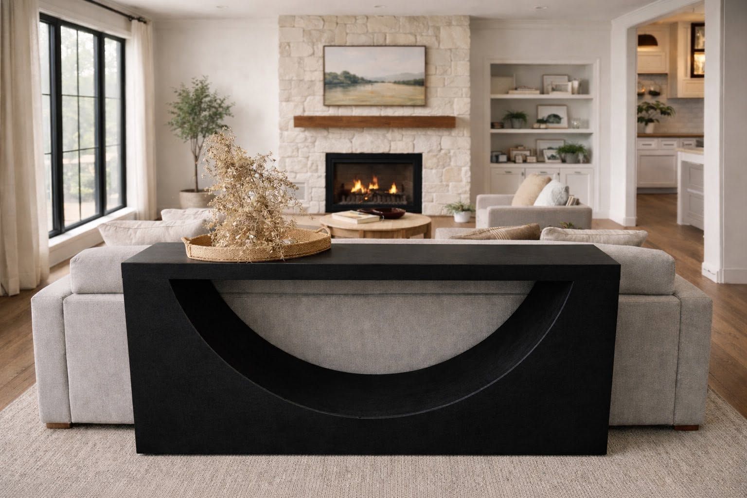 A black foam console table with an arc cutout styled behind a sofa