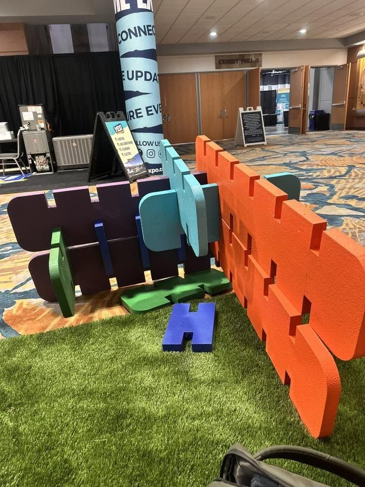 A colorful interlocking foam display structure set up at a trade show
