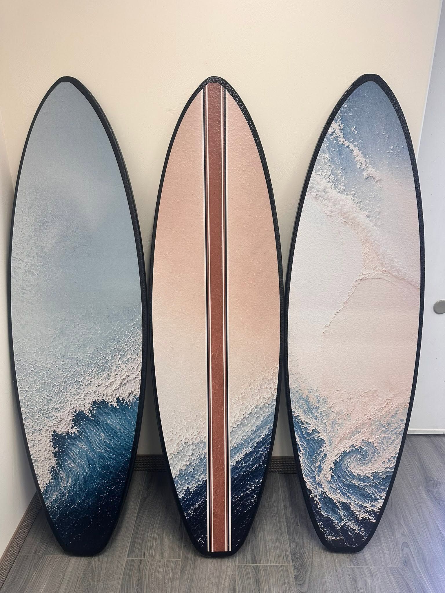 Three decorative foam surfboards finished as ocean wall art